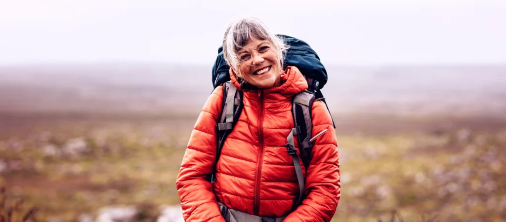 A woman hiking along a scenic outdoor trail.